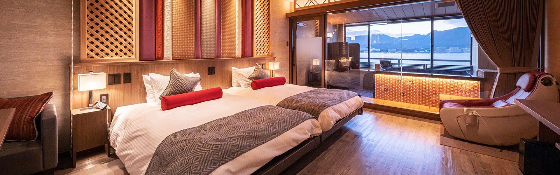 Miyajima Kinsuikan a twin bedroom with broad windows facing the water.