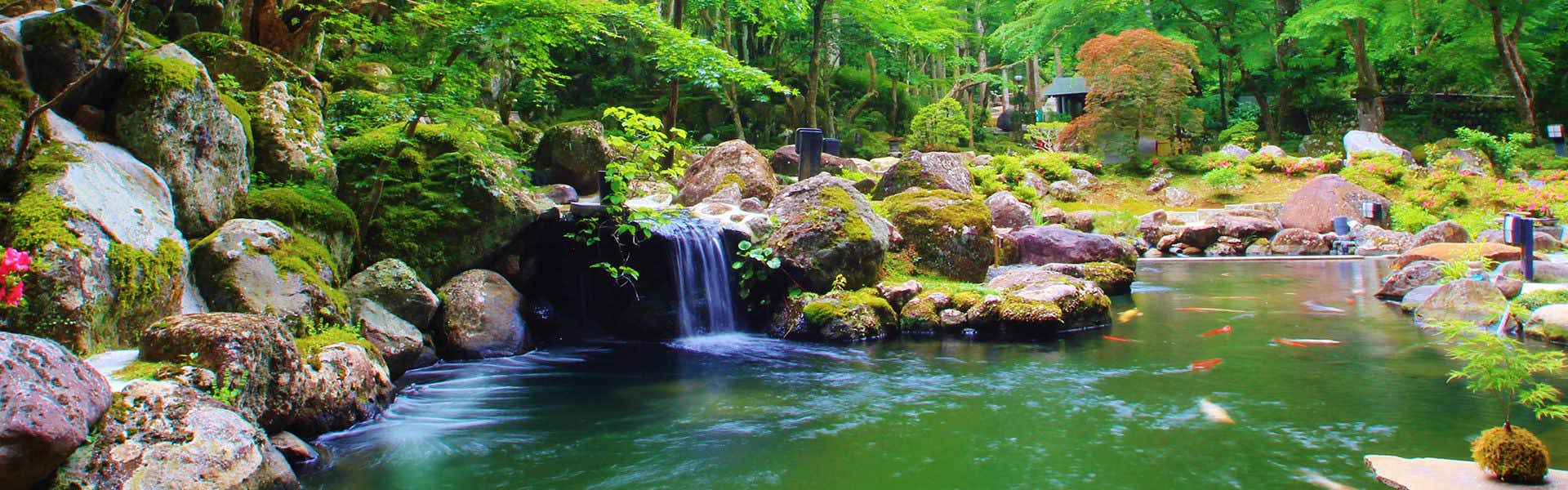 SORA Togetsusou Kinryu with a landscaped pond fed by a small garden waterfall.