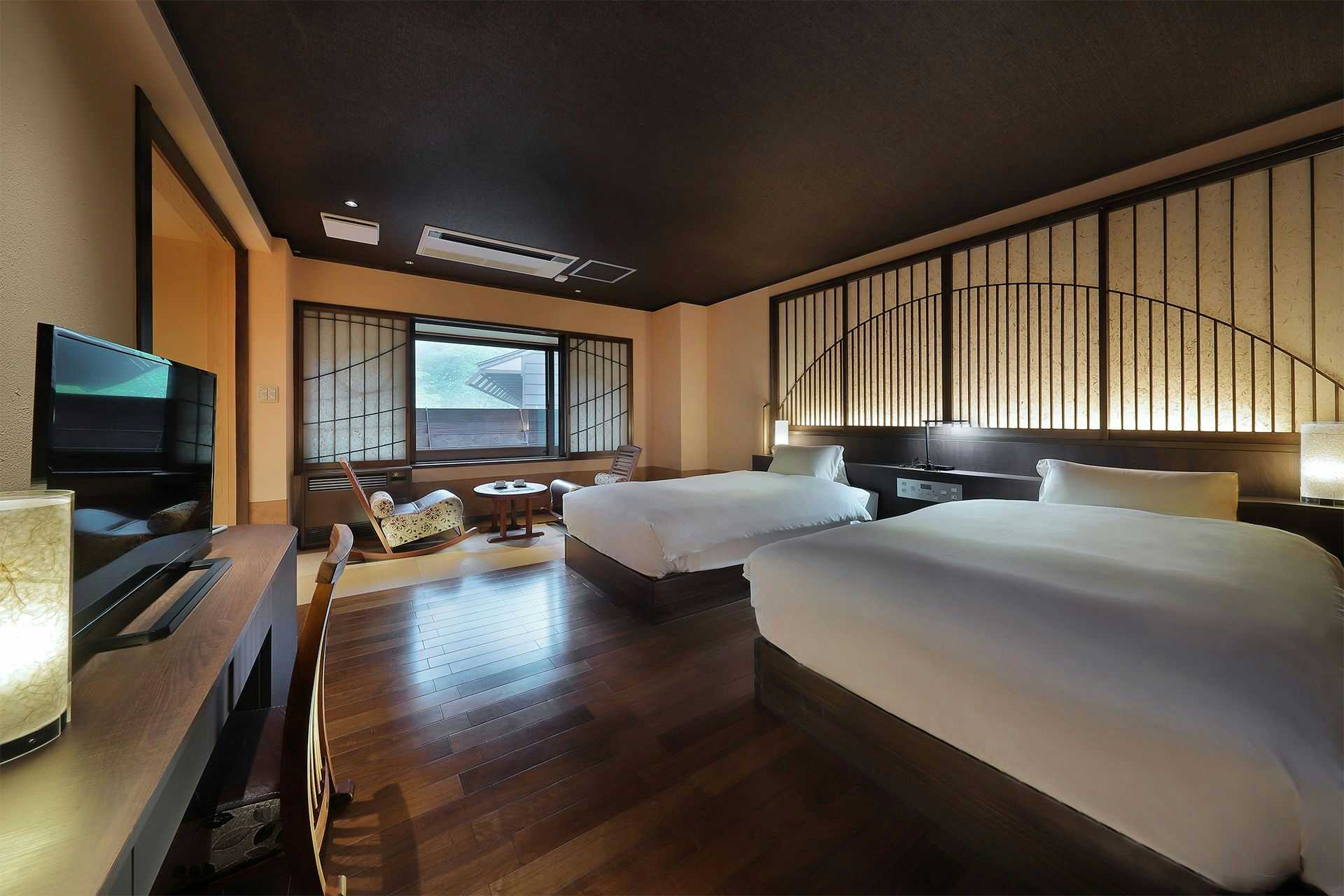 Oomaru Onsen Ryokan with a modern twin suite with timber floors and tatami seating.