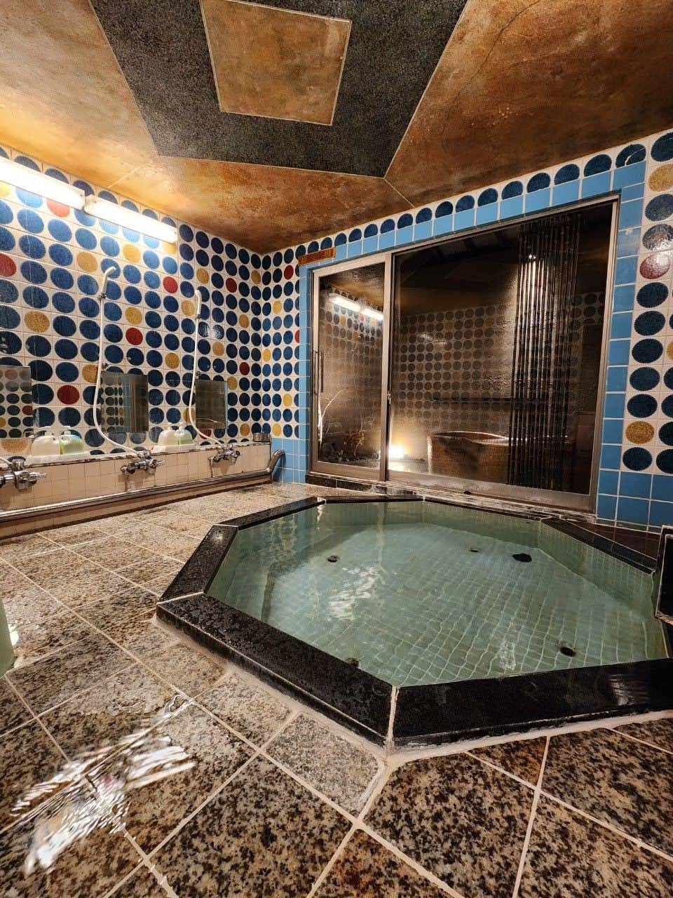Tomitaya Annex with an indoor tiled bath accented by colorful circular patterns.