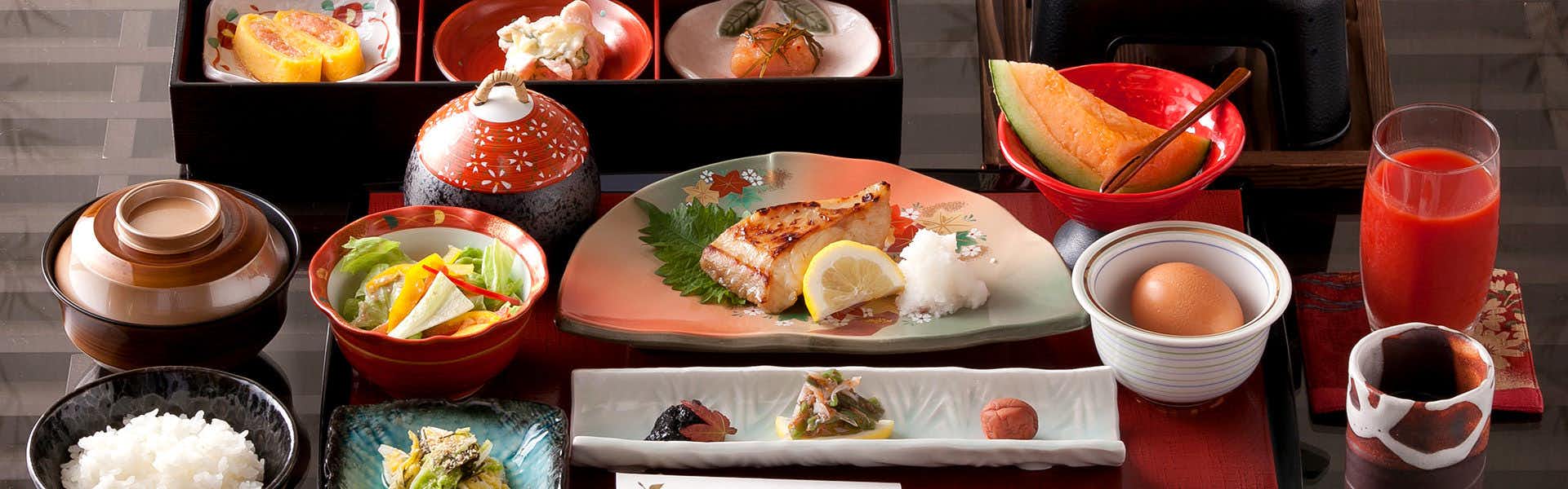 Healing Inn Takakatsu with a traditional breakfast served with numerous small dishes.