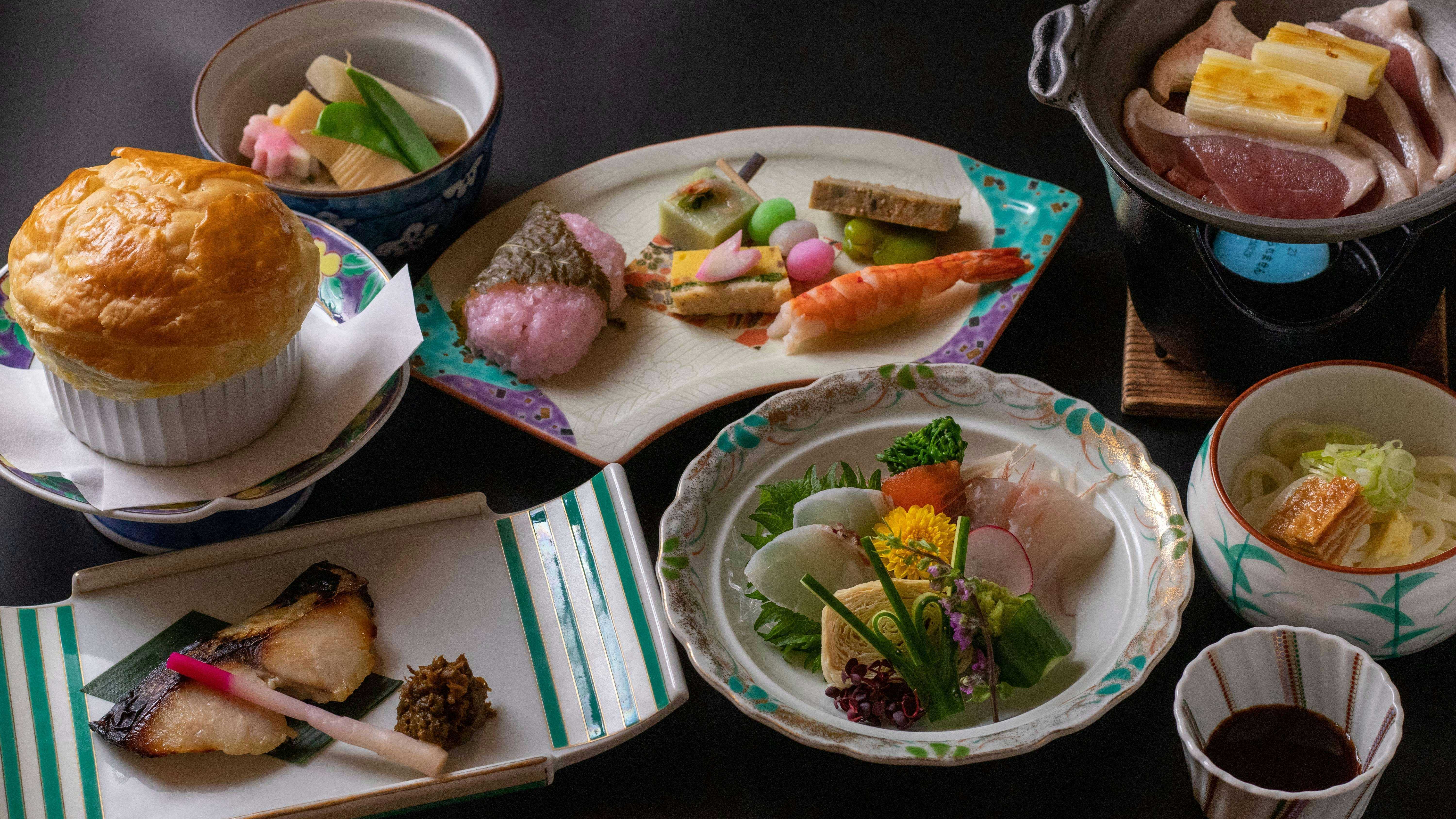 Shima Onsen Mikiya Ryokan with a multi-course Japanese meal featuring sashimi and a baked pastry.