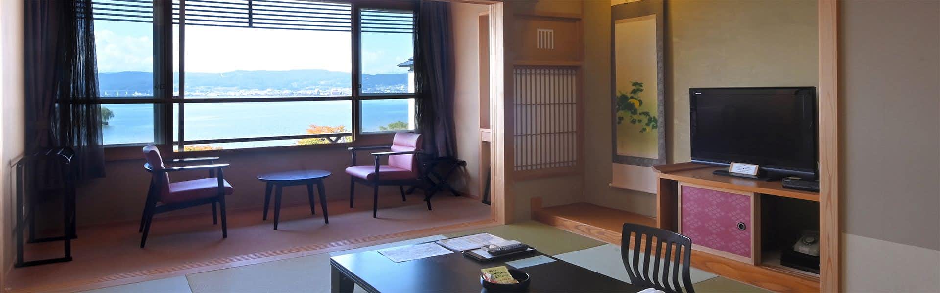 Nuno Han with a traditional room with low table and lake-facing windows.