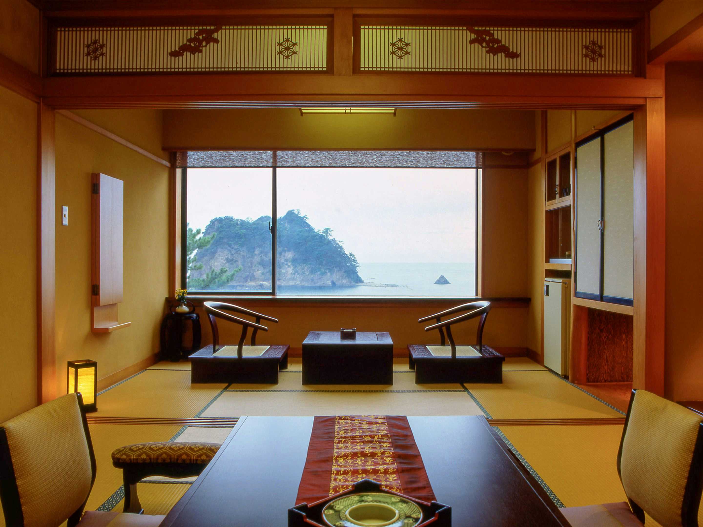 Seiryu Seaside Sunset Onsen Ryokan with a traditional tatami room framing the sea through a broad window.
