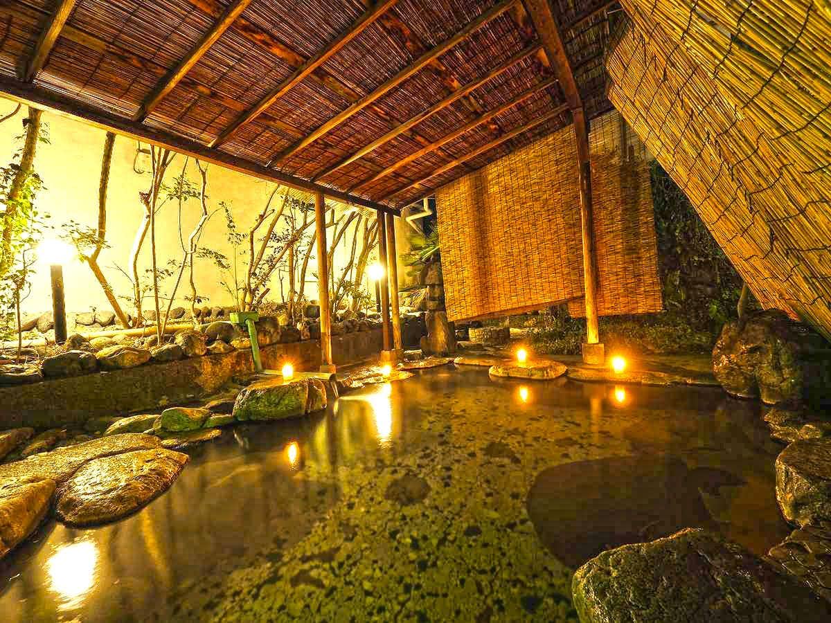 Shiobara Onsen Tokiwahotel with an outdoor rock bath illuminated beneath a woven shelter.