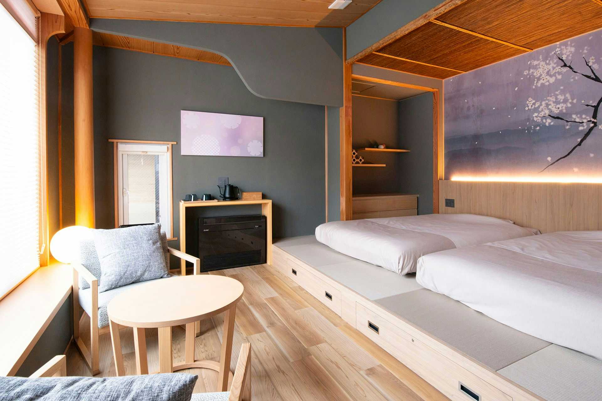 Matsurube Onsen Kamikura twin-bed room with a floral mural and pale wood details
