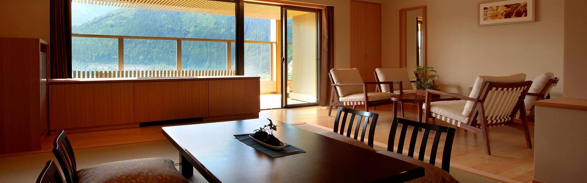 Naruko Hotel with a modern guest room opening toward a mountain balcony.