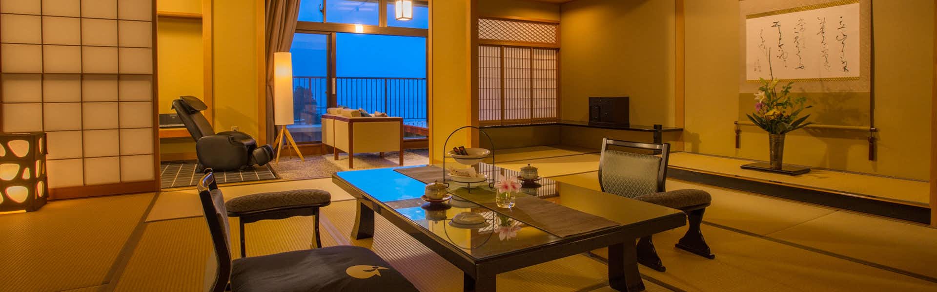 Himi Onsenkyo Relaxing Inn Umikari with a traditional tatami room with low table and ocean window.