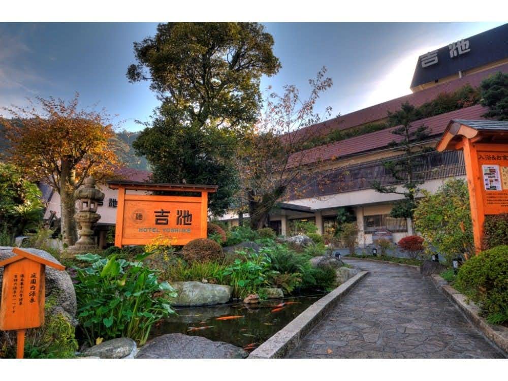 Yoshiike Ryokan with a stone garden path leading toward the traditional entrance.