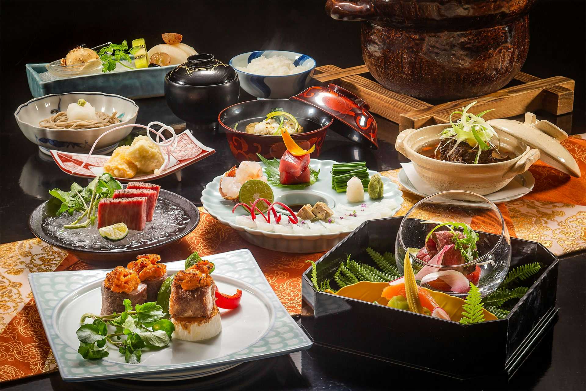 Ryotei Ryokan Yasui elaborate meal spread with many small dishes and tabletop pots