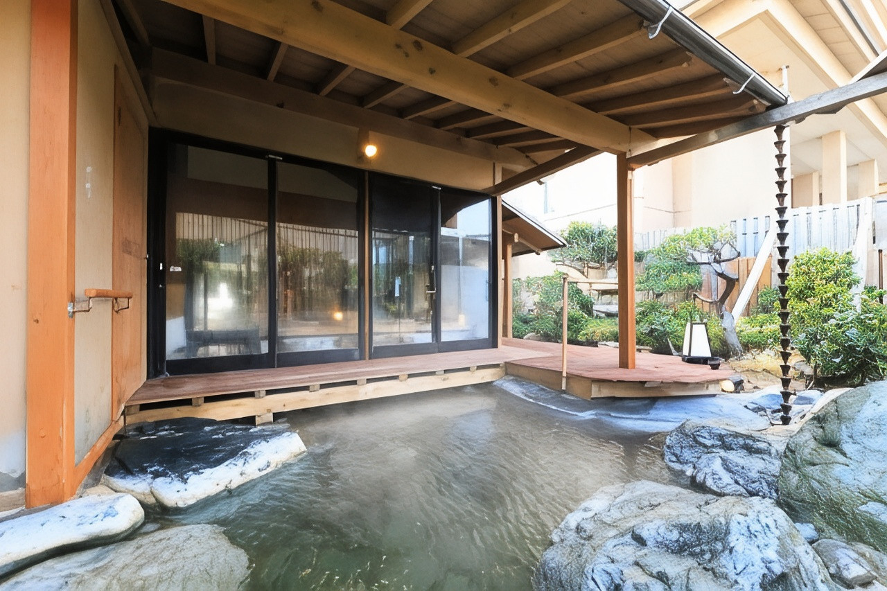 A rocky outdoor pool is surrounded by timber and glass.