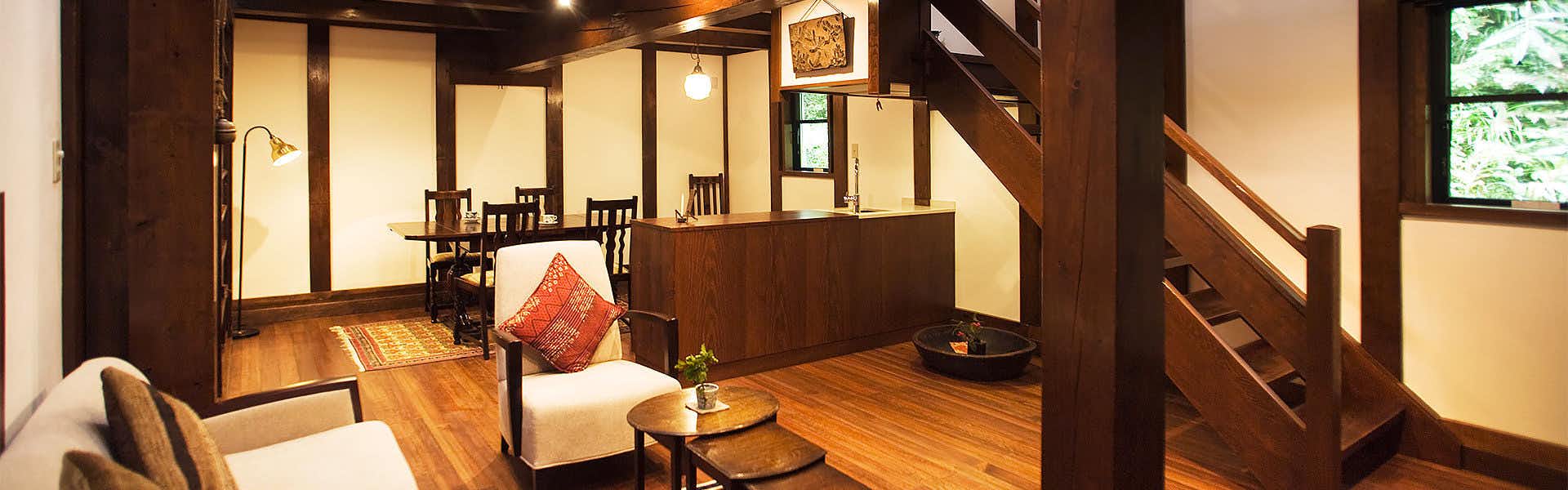 Kanazawa Fukatani Onsen Motoyu Ishiya - A Secluded Inn with a Noh Stage timber interior with lounge seating, dining area and stairs