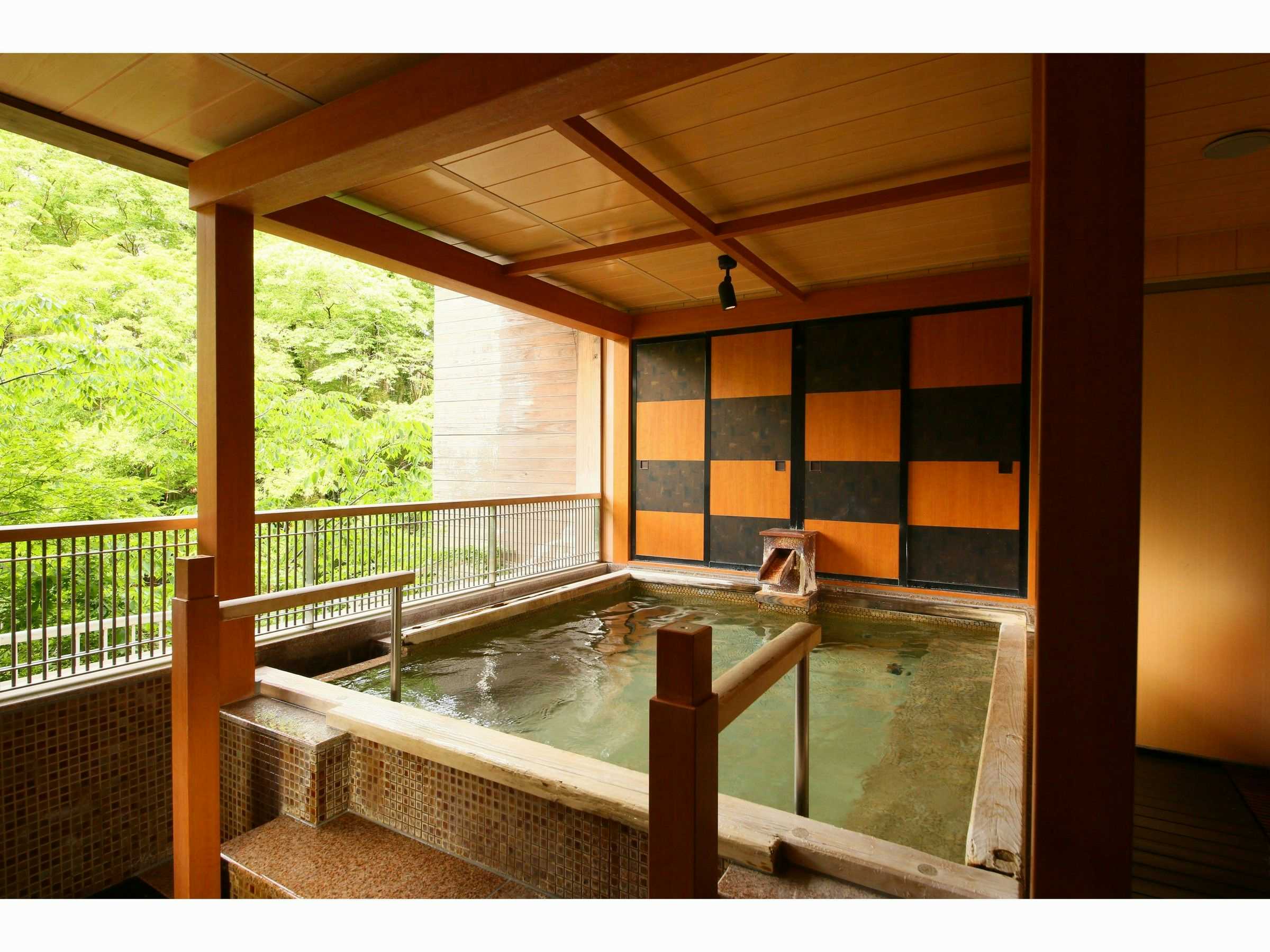 Hotel Miyama with an open-air mineral bath framed by timber railings.