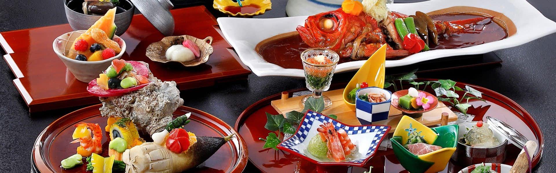 Minamiboso Katsuura Suika with a colorful seafood dinner arranged across red lacquerware.