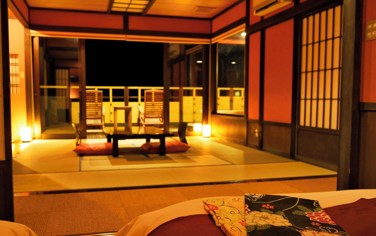 Japanese-style room opened toward the sea at night.