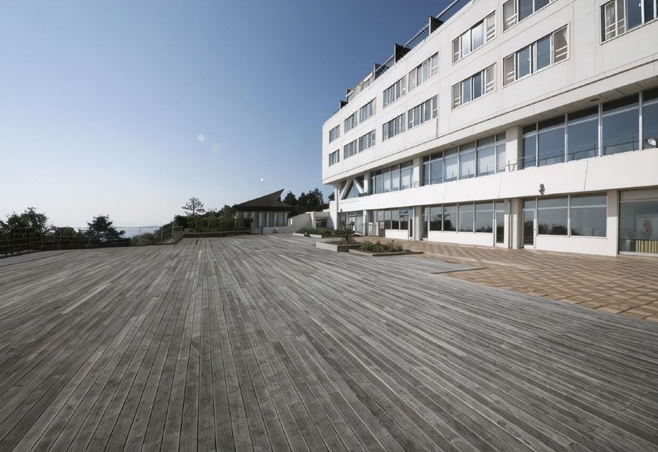 A broad hotel terrace stretches toward the sea.