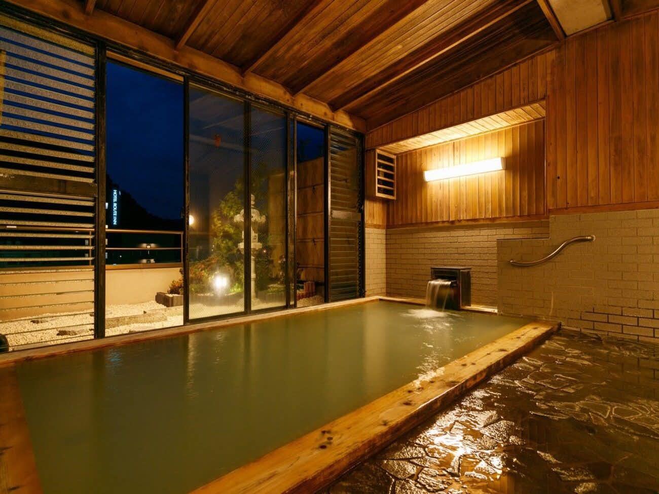 Tokura Kamiyamada Onsen Umemura Ryokan Uguisutei with a rectangular indoor bath lined with warm timber walls.