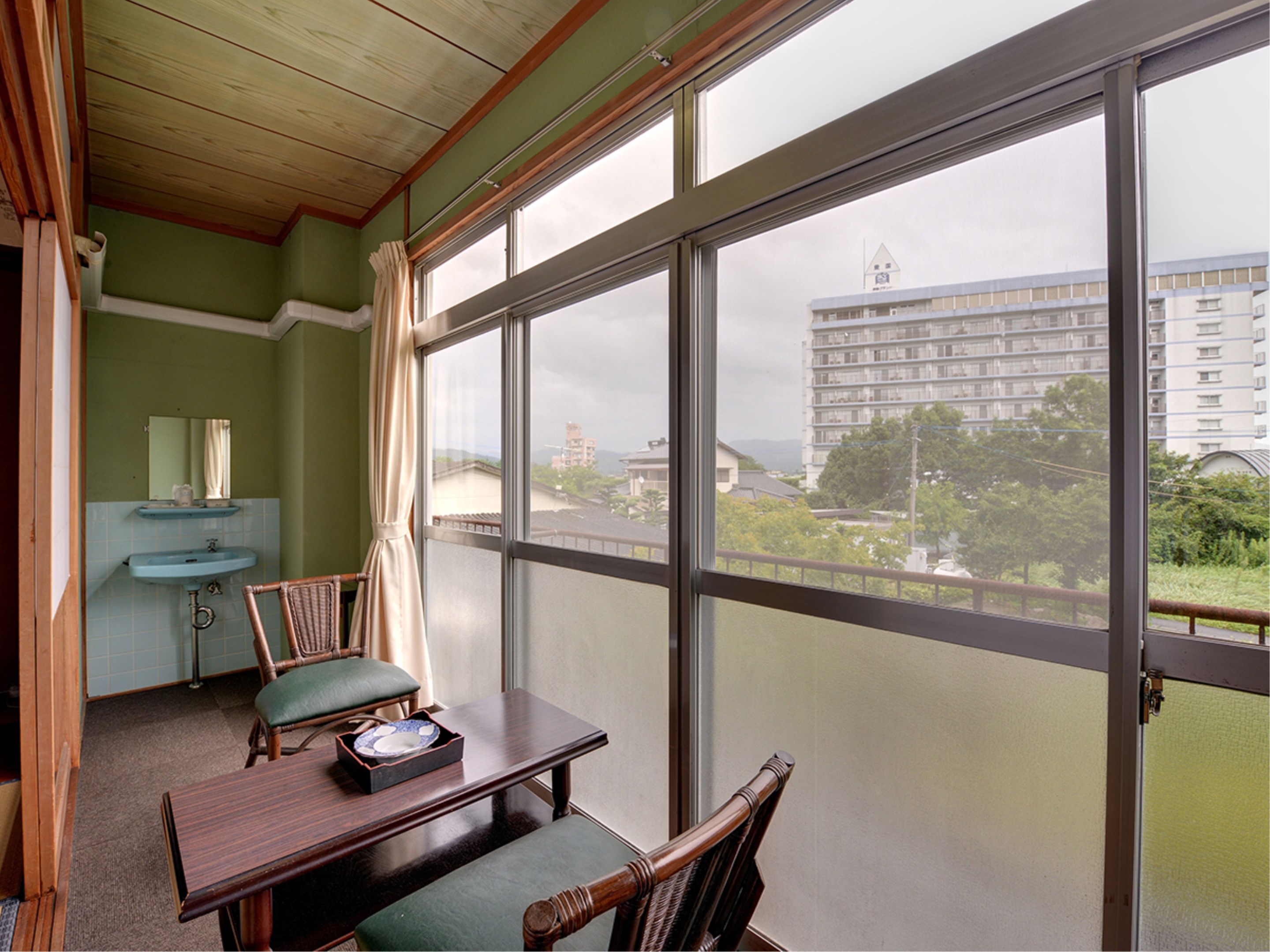 Room with chairs beside a window.