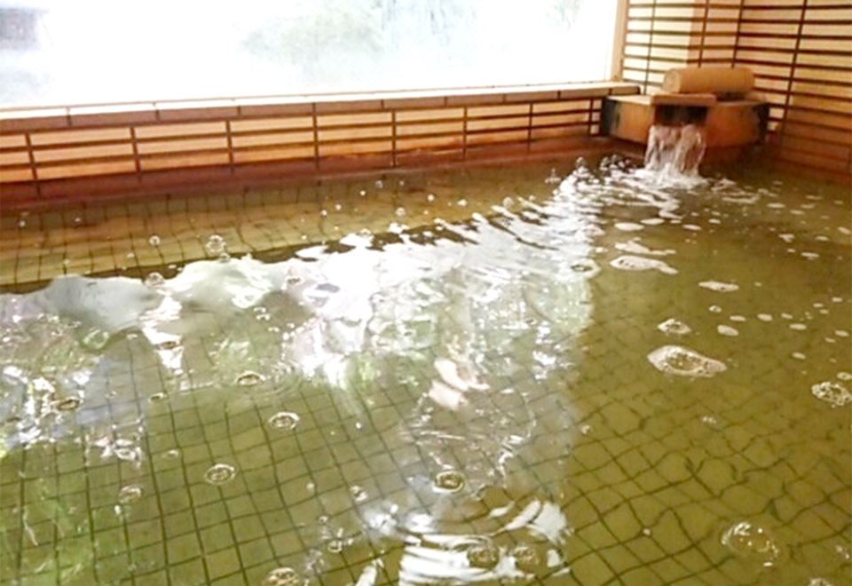 A close view of rippling water in a tiled indoor bath.