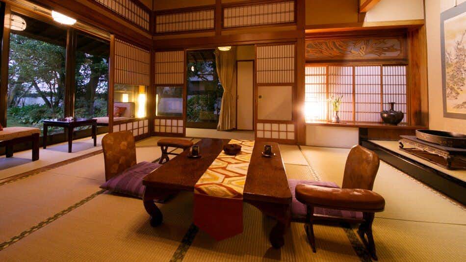 Karatsu Onsen Ryokan Wataya with an elegant tatami room with low table and garden-facing windows.