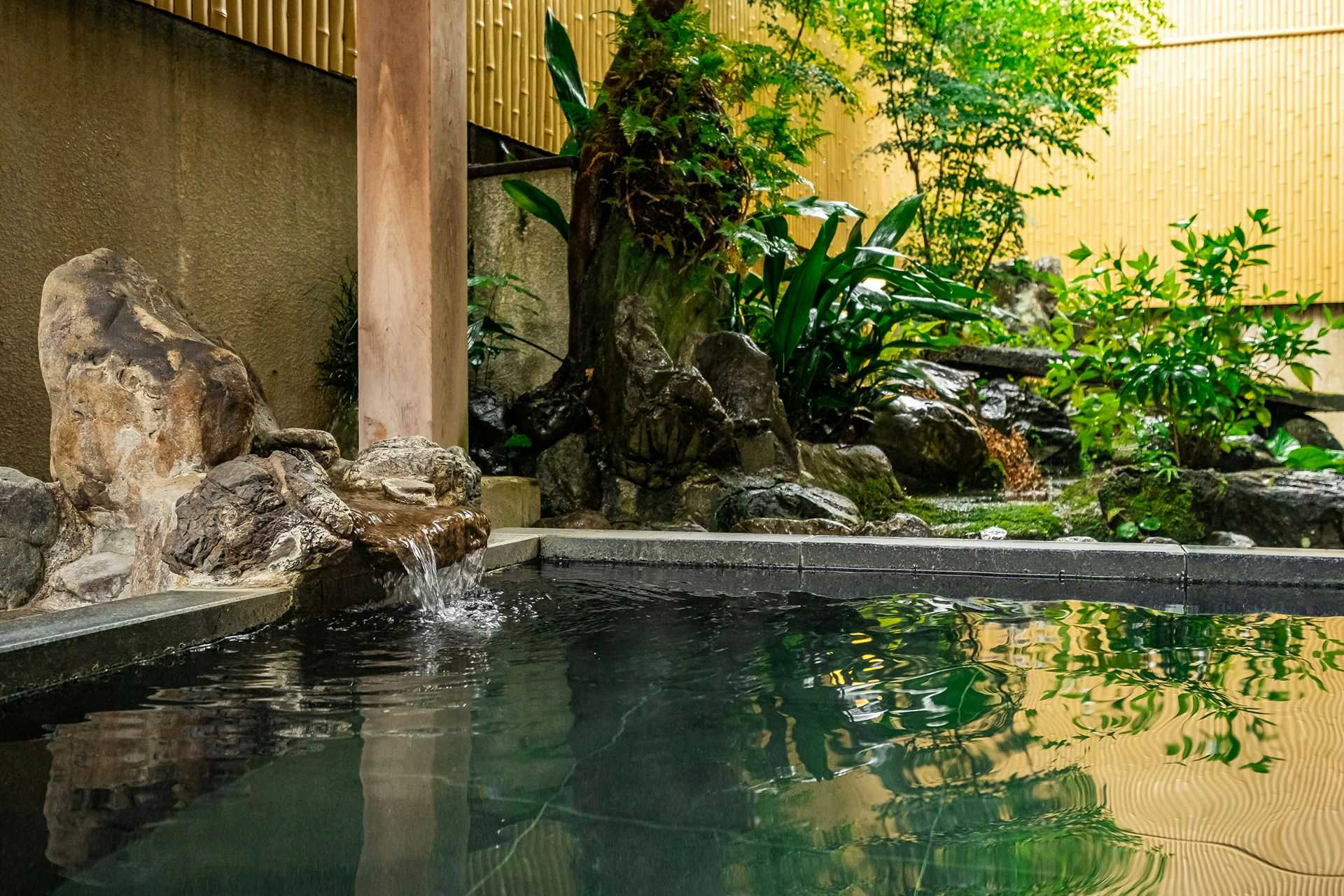 Seseragi no Yado Kuretake with an outdoor stone bath beside a compact garden.