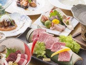 Aso no Tabiyado Takanosho with a refined dinner arranged around sashimi and marbled beef.