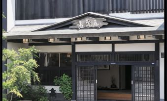 A traditional building entrance with a tiled canopy.