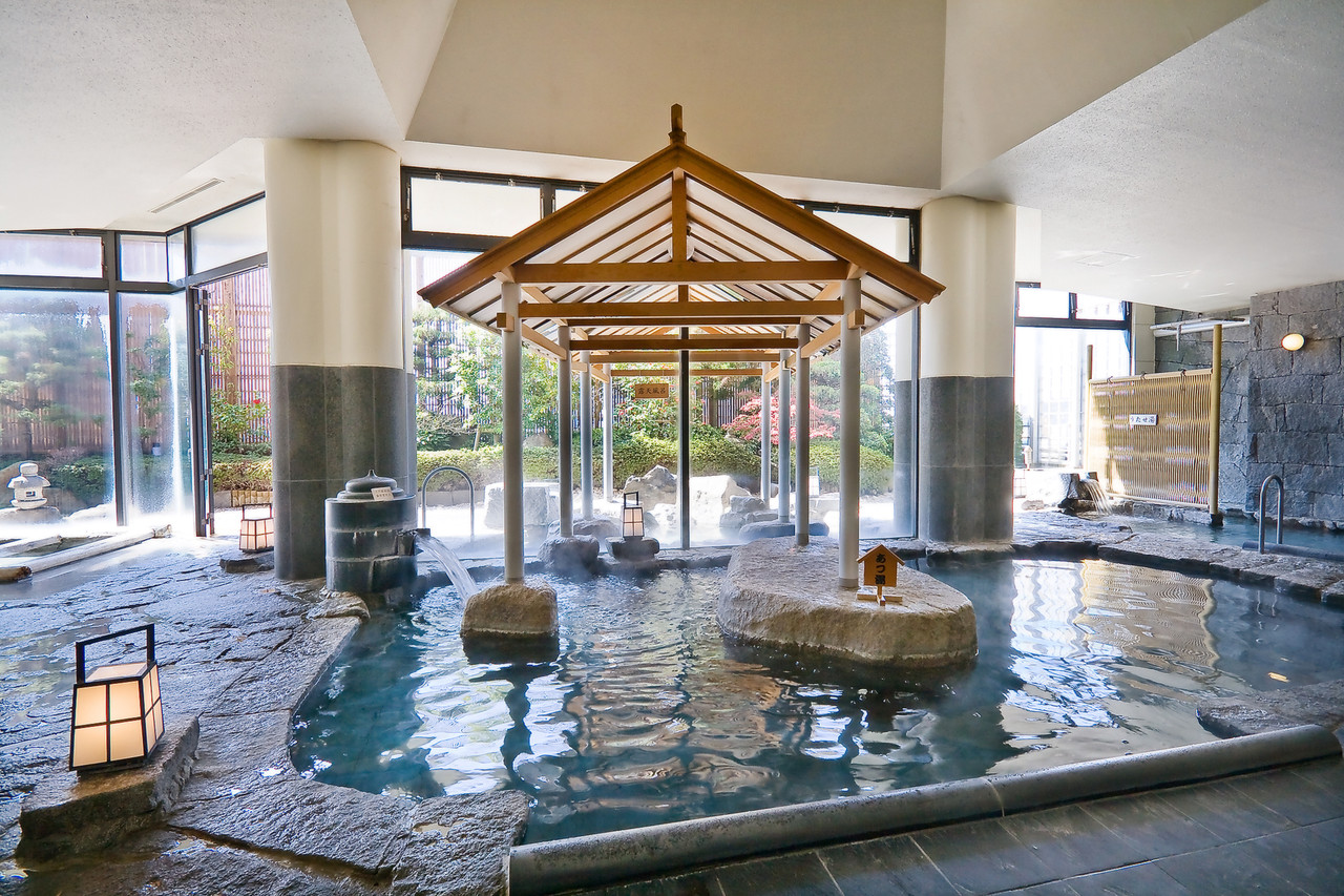 Indoor bath with a central roofed feature.