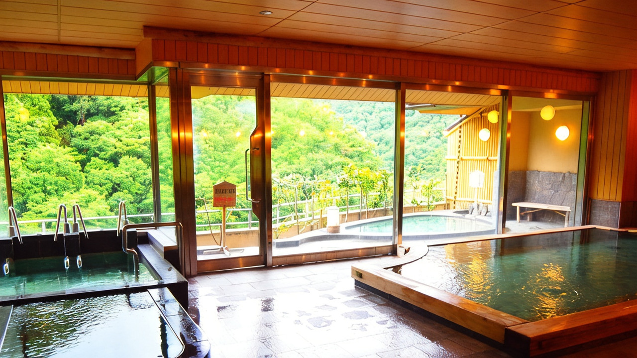 A wooden indoor bath beside large windows.