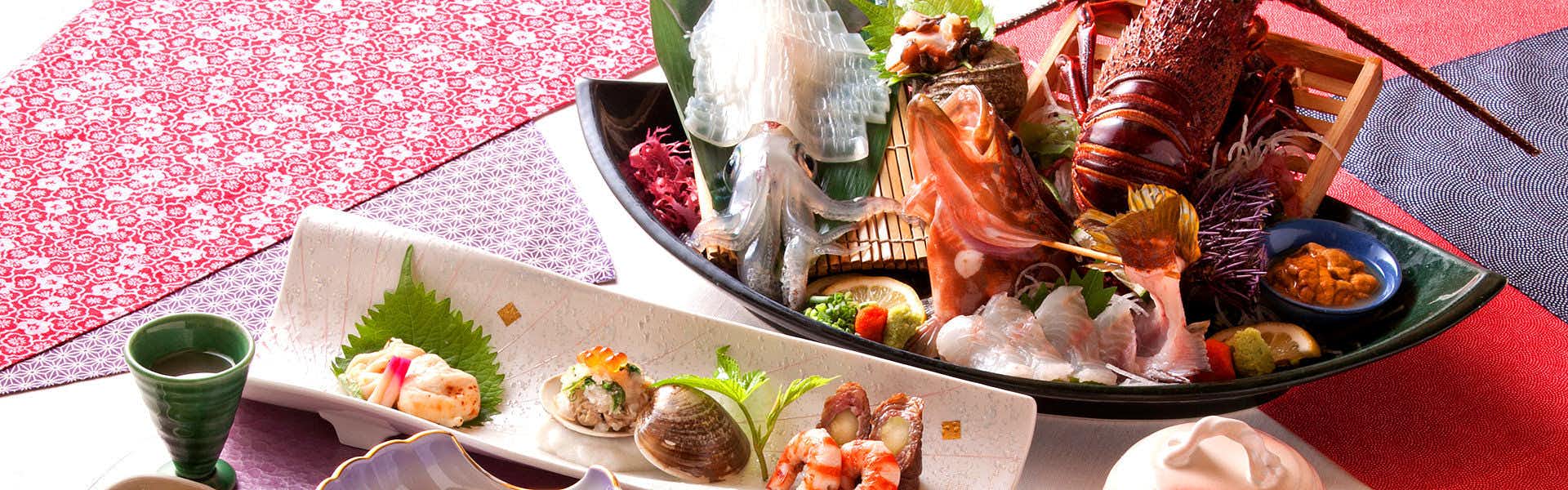 Healing Inn Takakatsu with a generous Japanese dinner arranged across red tableware.