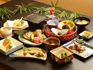 Nakajimaya Ryokan with a multi-course Japanese dinner across colorful ceramic dishes.