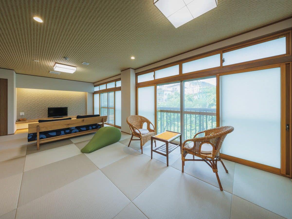 Okina Ryokan with a bright tatami guest room overlooking the river.