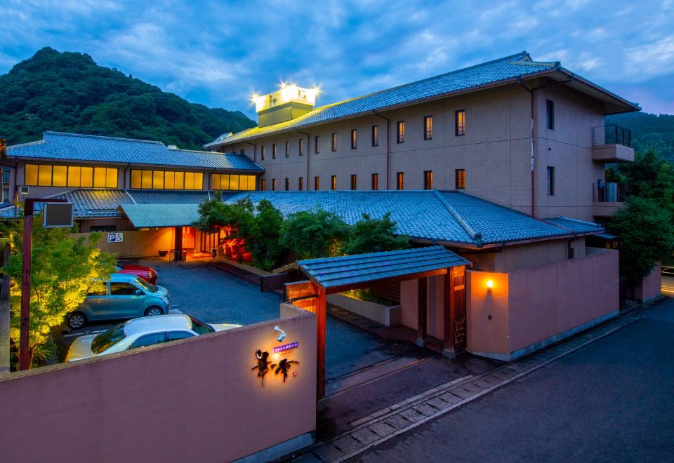 The lodging buildings beneath a blue evening sky.