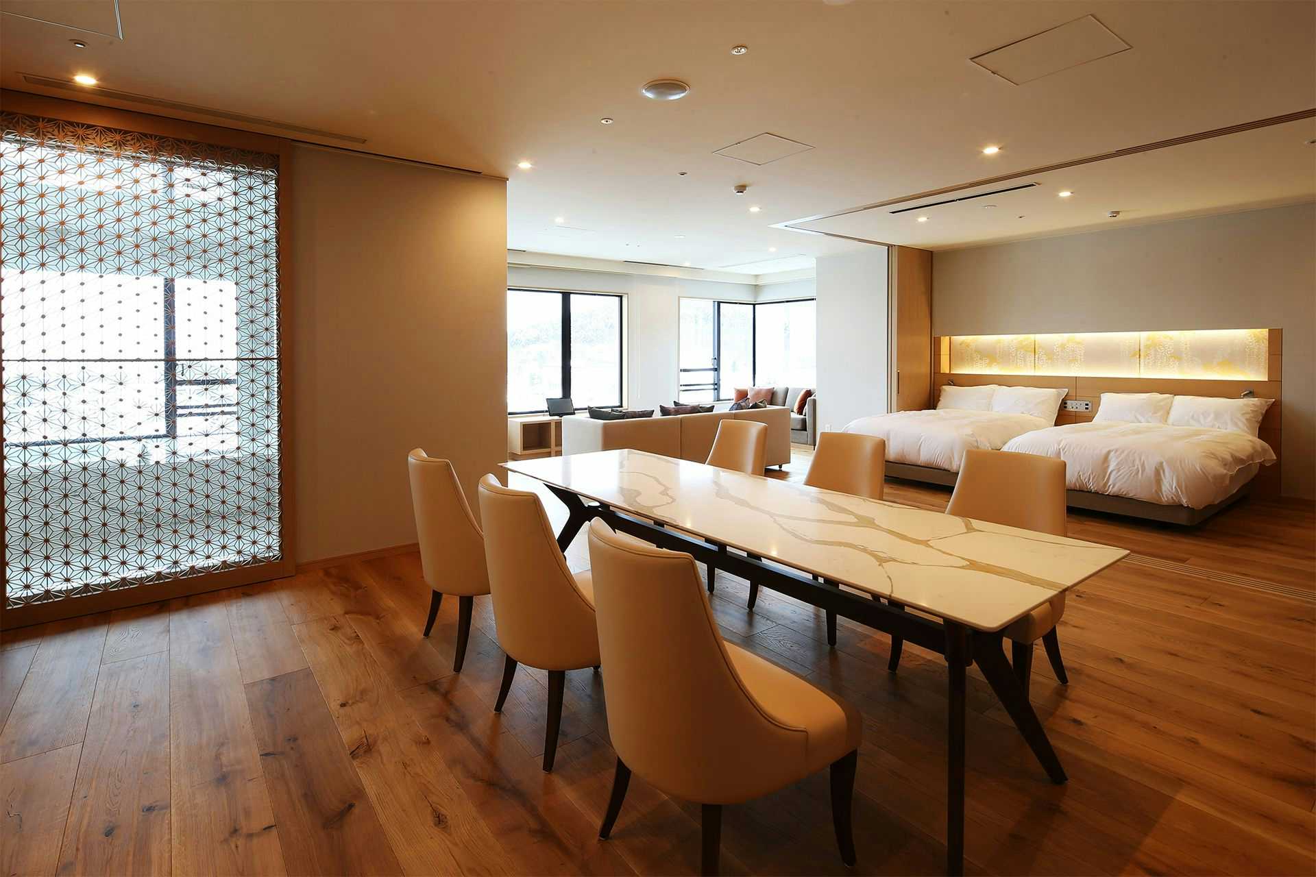 Kusatsu Onsen Hotel Sakurai with a modern suite with dining table, twin beds, and lounge seating.