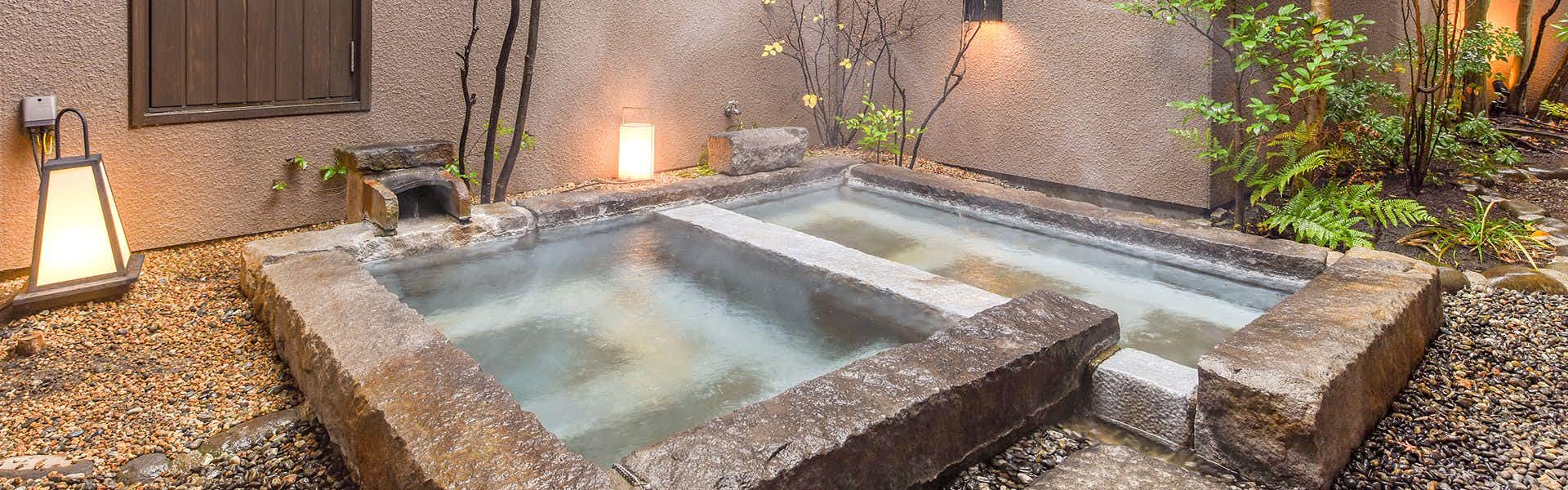 Kotenngu Sanroji with a private stone bath set within a lantern-lit courtyard.