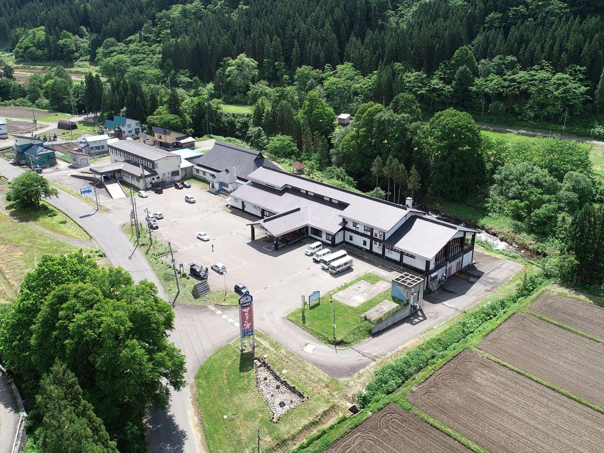 Utto Onsen "Matagi no Yu" with the secluded property surrounded by densely forested mountains.