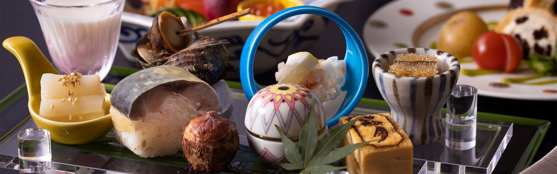 Kappo Ryokan Echizen Mangetsu Multiple plated food courses with colorful cooked items on white dishes.