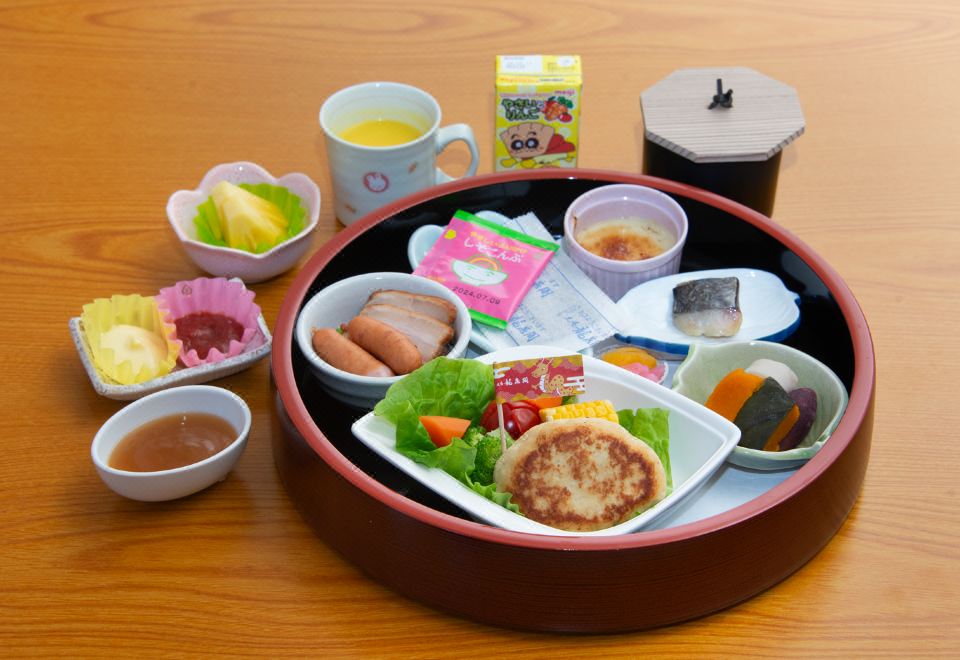 A meal tray with rice, small dishes, and juice.