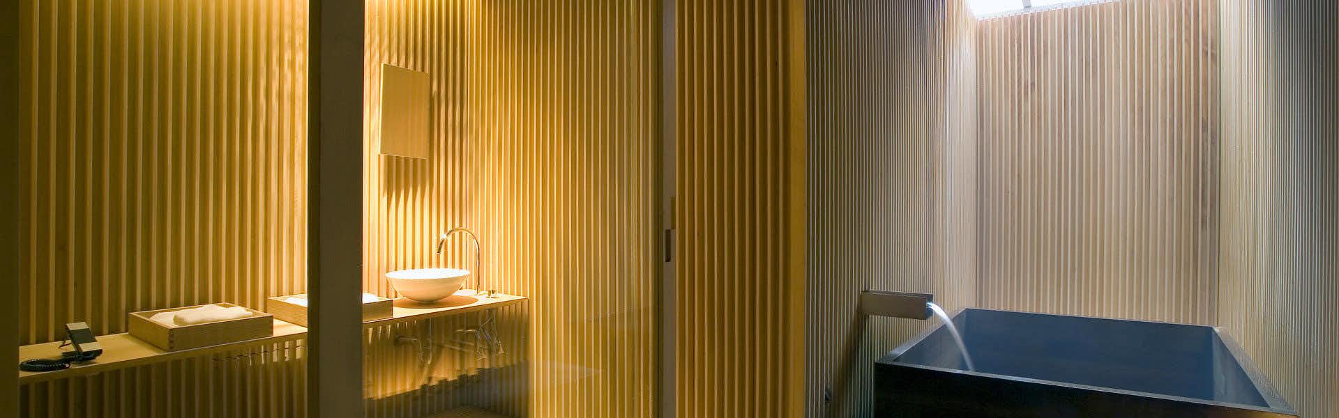 Ryokan Fujiya with a private soaking bath enclosed by vertical timber screens.