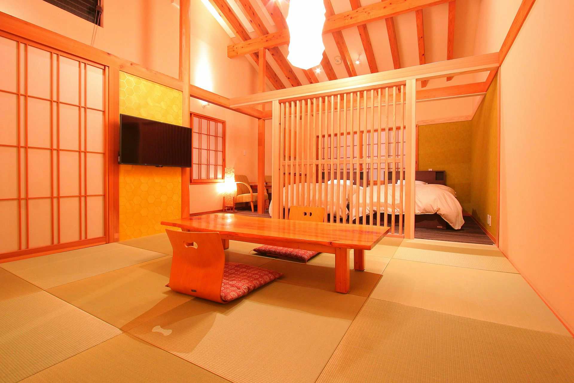 Jubei no Yado with a warm timber suite with raised bed and low table.