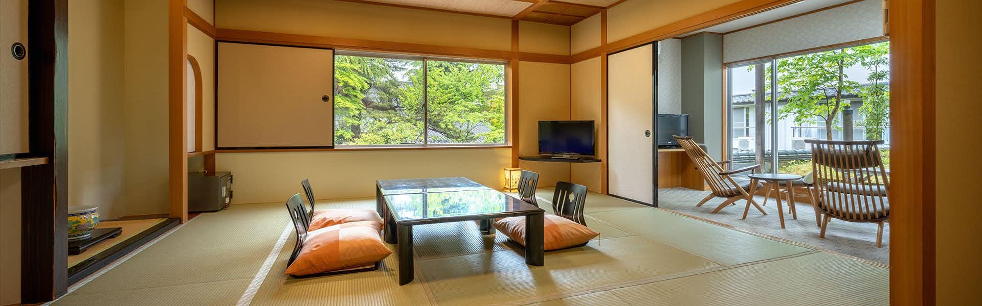 Adatara no Yado Ogiya with a calm tatami room with low table and garden windows.