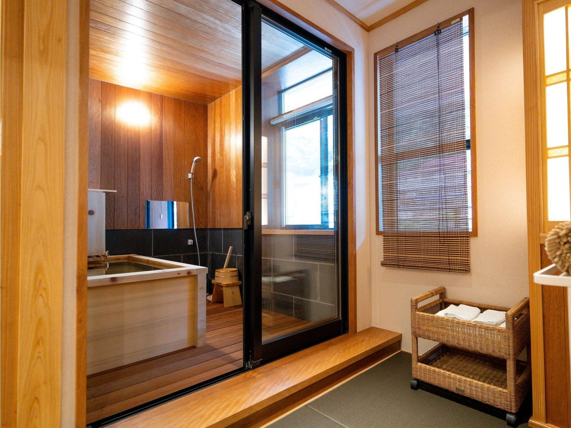 A wood-paneled washing area with a small bath.