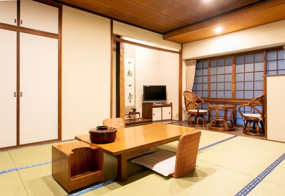 A tatami guest room with a low table and window seating.