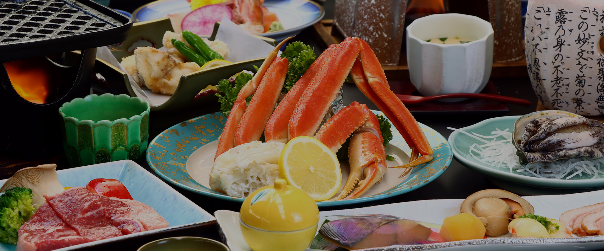 Crab legs and assorted dishes are presented across a dining table.