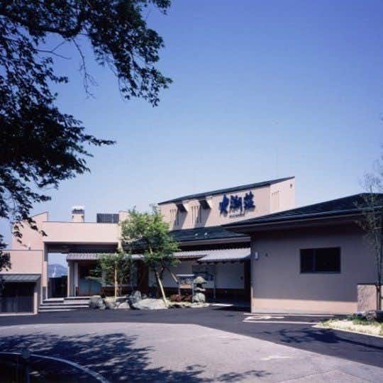 Daichoso low modern lodging exterior surrounding a paved courtyard