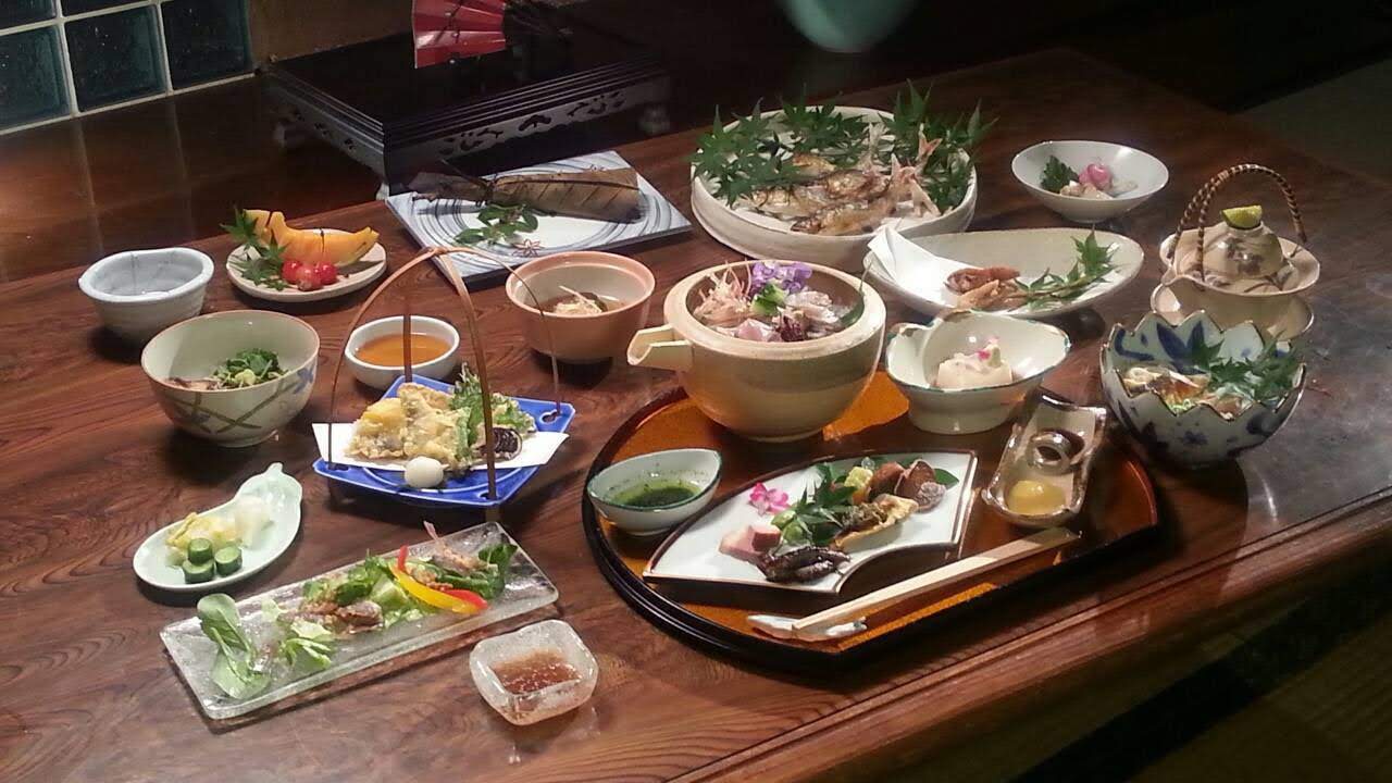 Dining table set with multiple dishes.