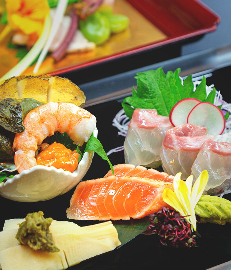 Kyoto Keburikawa with a plated course of sashimi, vegetables, and small dishes.