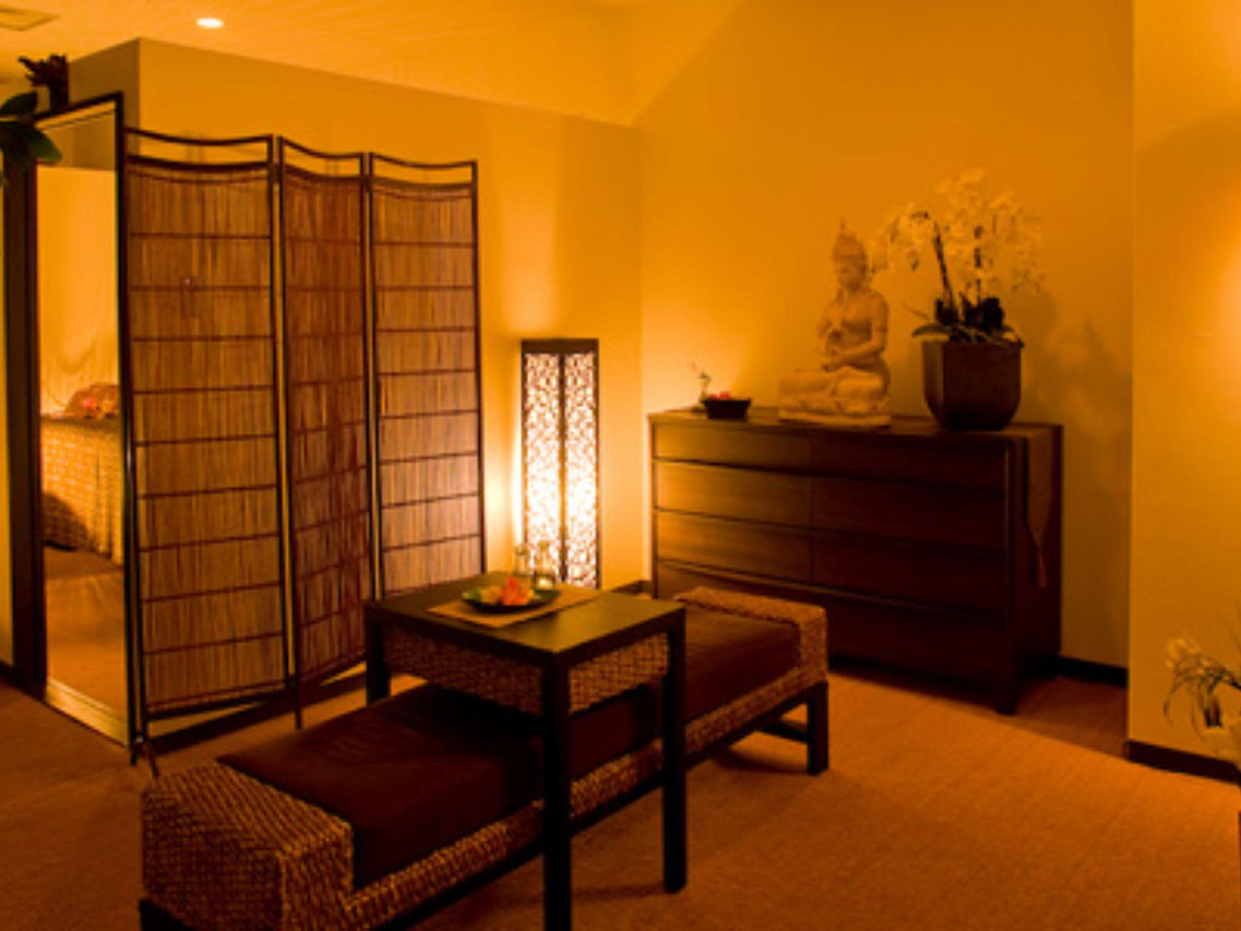 A softly lit lounge with traditional screens and wood furnishings.