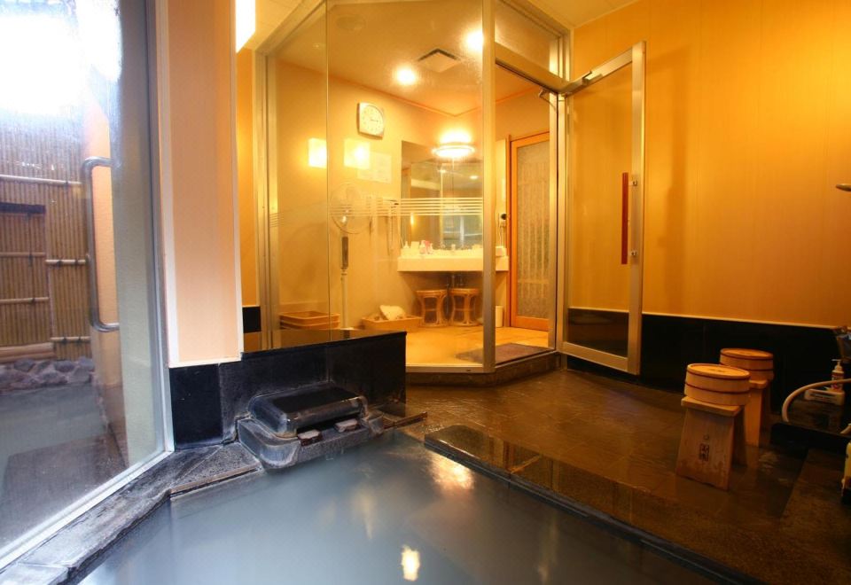 Indoor bath beside a window.