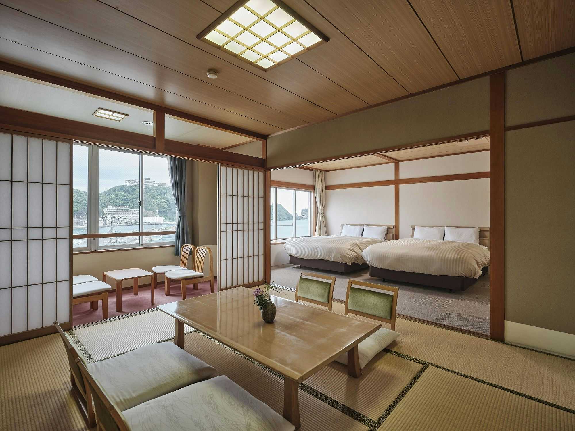 Manseirou with a bright hybrid room with twin beds and low timber table.
